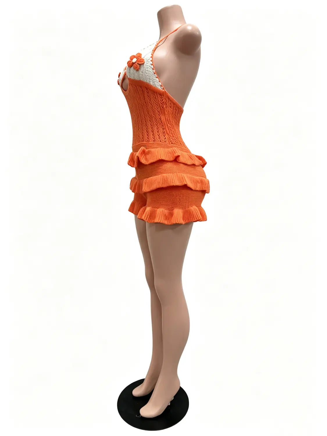 Vibrant orange knitted ruffle halter romper summer playsuit with tiered ruffles and a white crocheted floral accent at the neckline.
