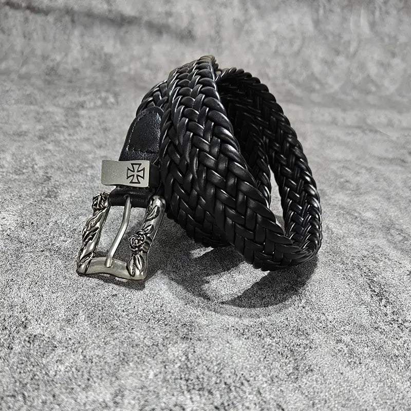 Black braided leather fashion belt male with a silver-toned buckle featuring an ornate rose design and a rectangular plate bearing a cross emblem luxury designer punk belt male cross.
