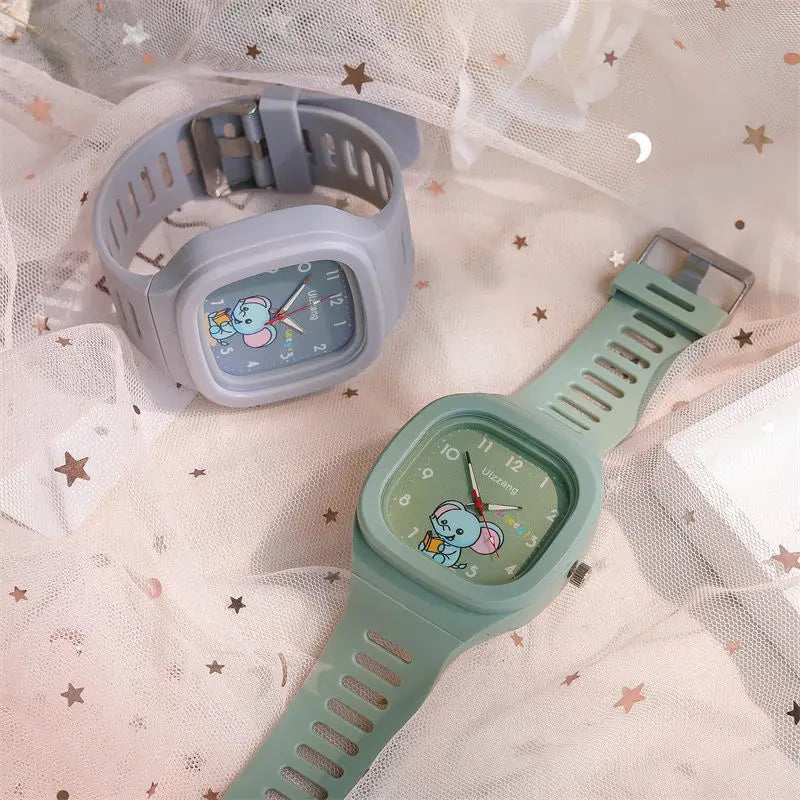 Kids luminous cartoon elephant digital watches with pastel green and light gray silicone straps and square faces featuring elephant designs.