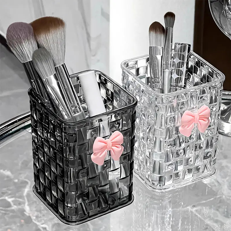 clear and black woven plastic bow pen holder desktop storage organizers each adorned with a pink bow