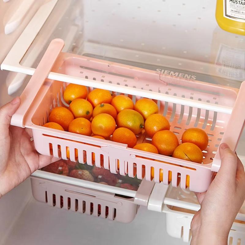 Pink plastic sink drain rack made of food-grade polypropylene with a slatted design and white clips for secure attachment.
