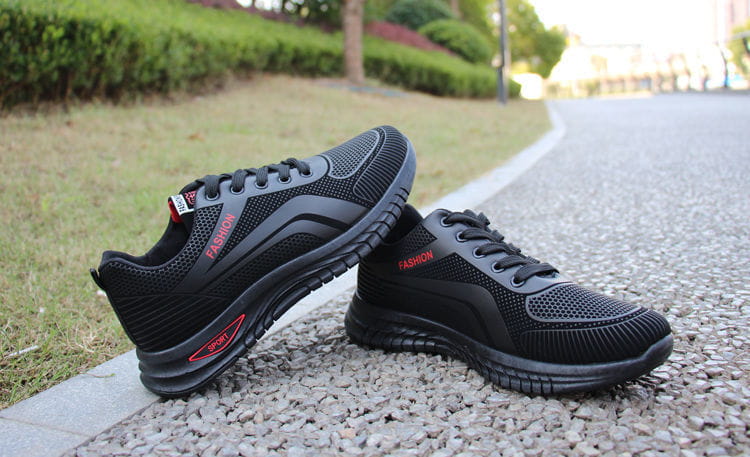 Men breathable athletic sneakers running shoes in black mesh with red fashion and sport branding featuring a sleek design and durable rubber sole.