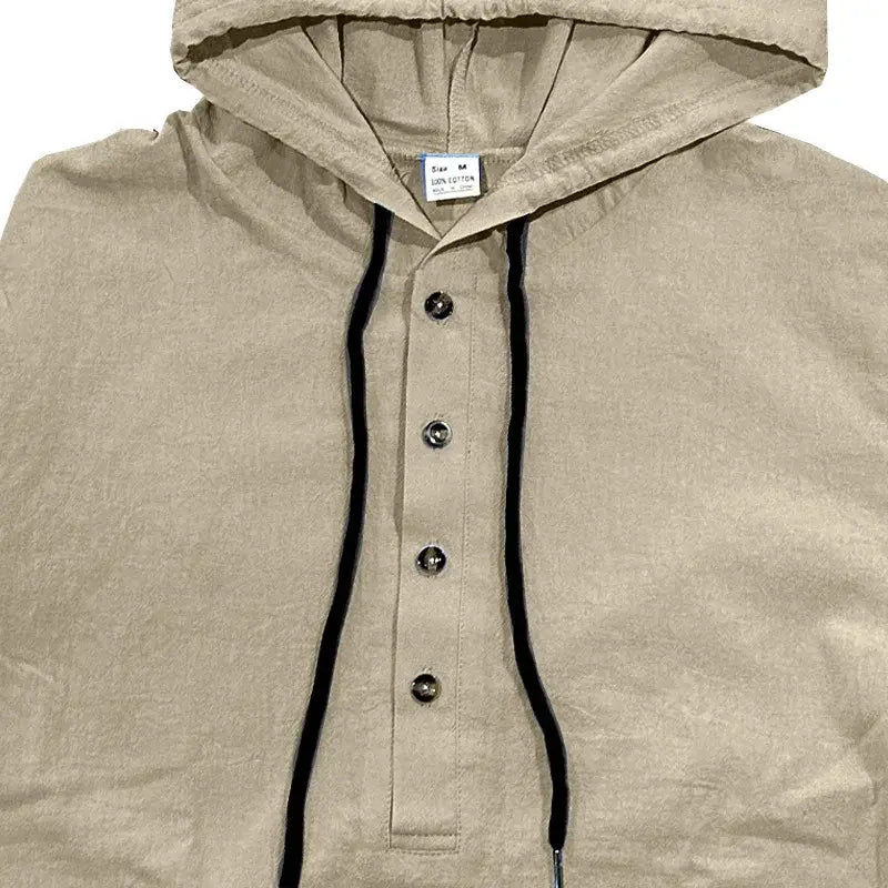 Beige men cotton linen hooded henley shirt featuring black drawstrings and silver buttons.