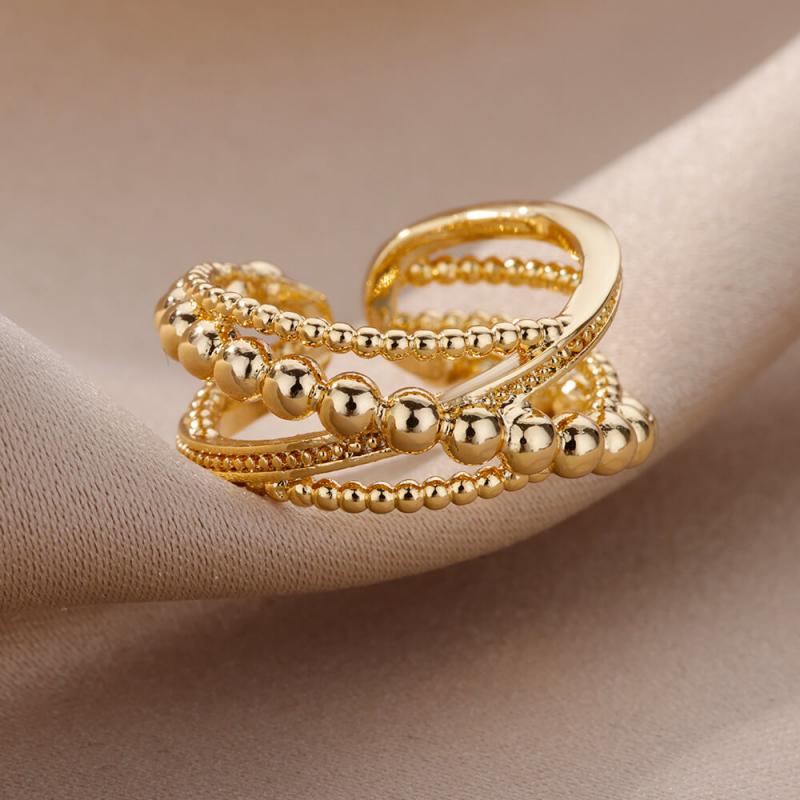 Gold-toned stainless steel rings for women featuring a multi-layer design with smooth and beaded textures and interwoven bands, suitable for vintage wedding jewelry.