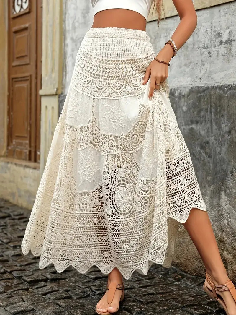 A flowing off-white crochet lace maxi skirt featuring intricate lace patterns and a scalloped hem ideal for summer wear.