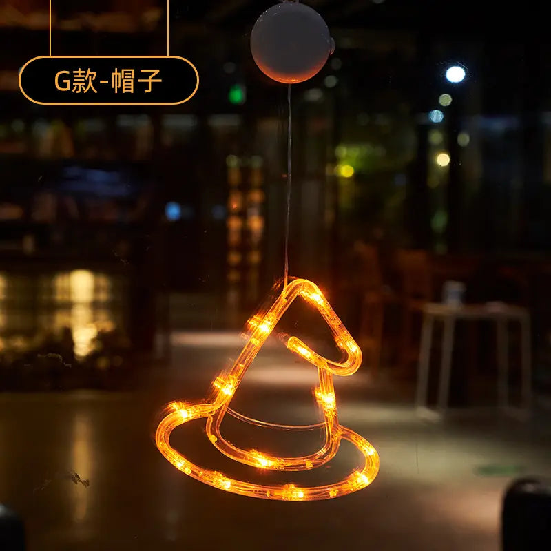 a glowing orange led light-up witch hat hanging ornament for halloween window light battery operated pumpkin ghost decor