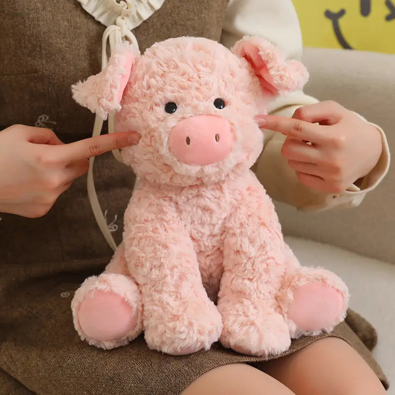 A soft fluffy pink plush stuffed animal toy pig measuring 25cm with textured fur-like material and a rounded snout.