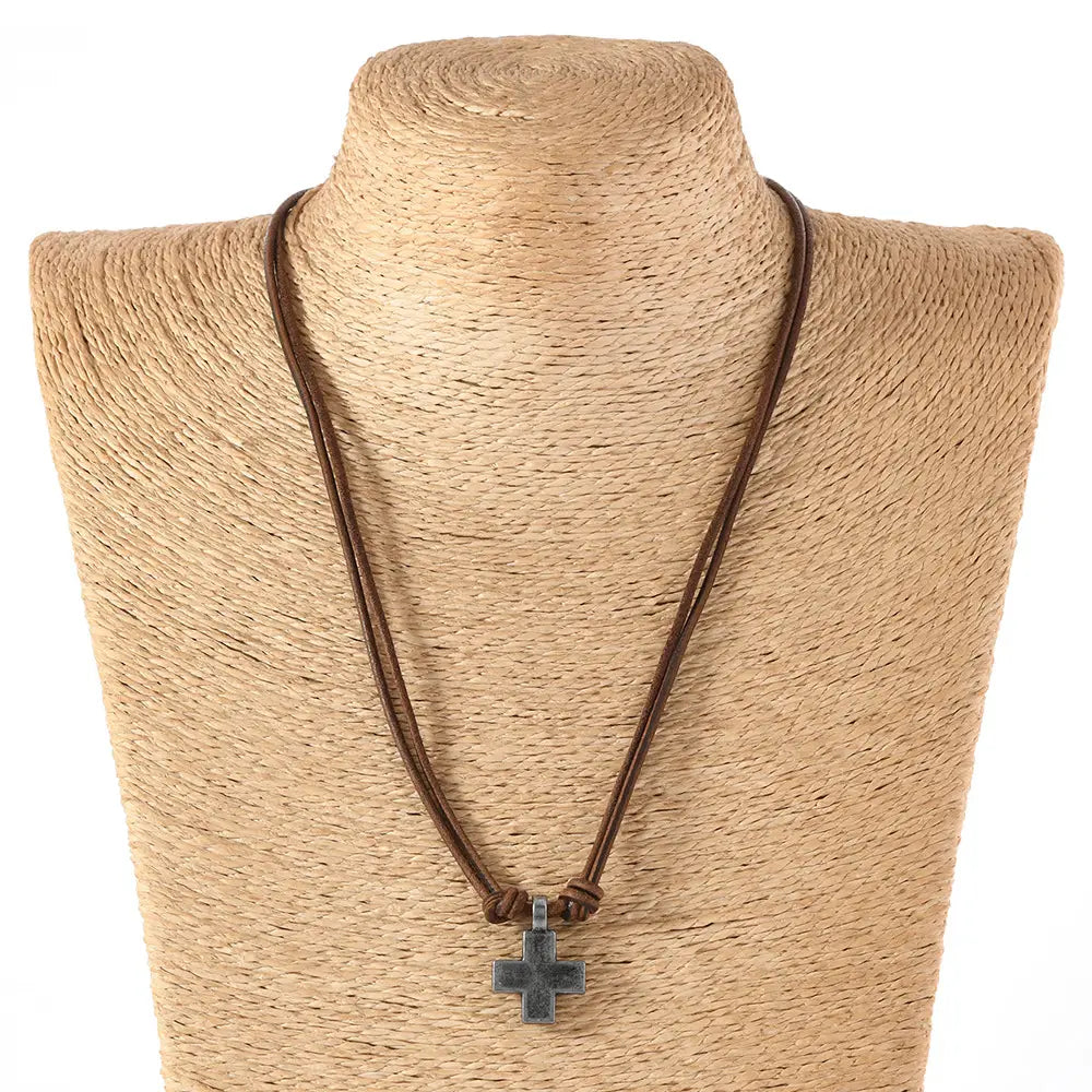 brown leather cord necklace featuring a dark textured cross pendant made of alloy material