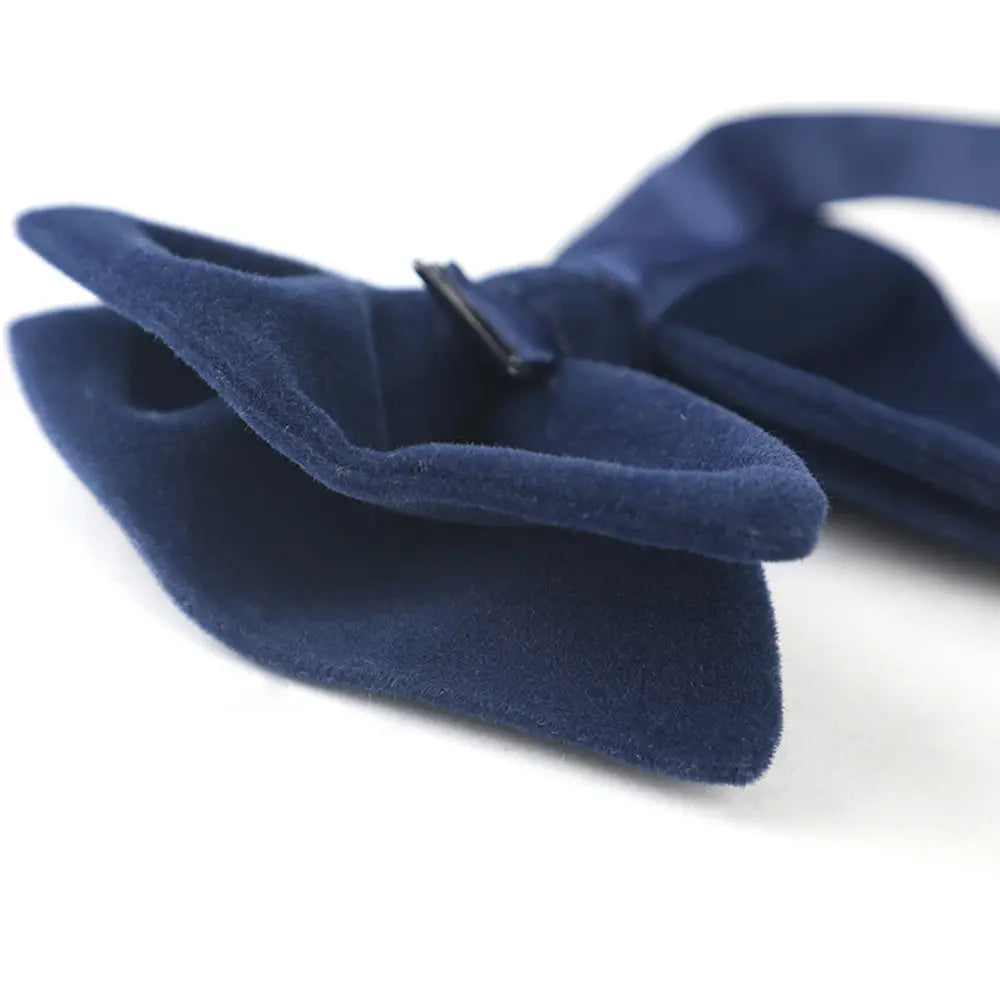 Deep navy velvet bow tie with a sleek black clasp designed as formal neckwear and an elegant gift option.