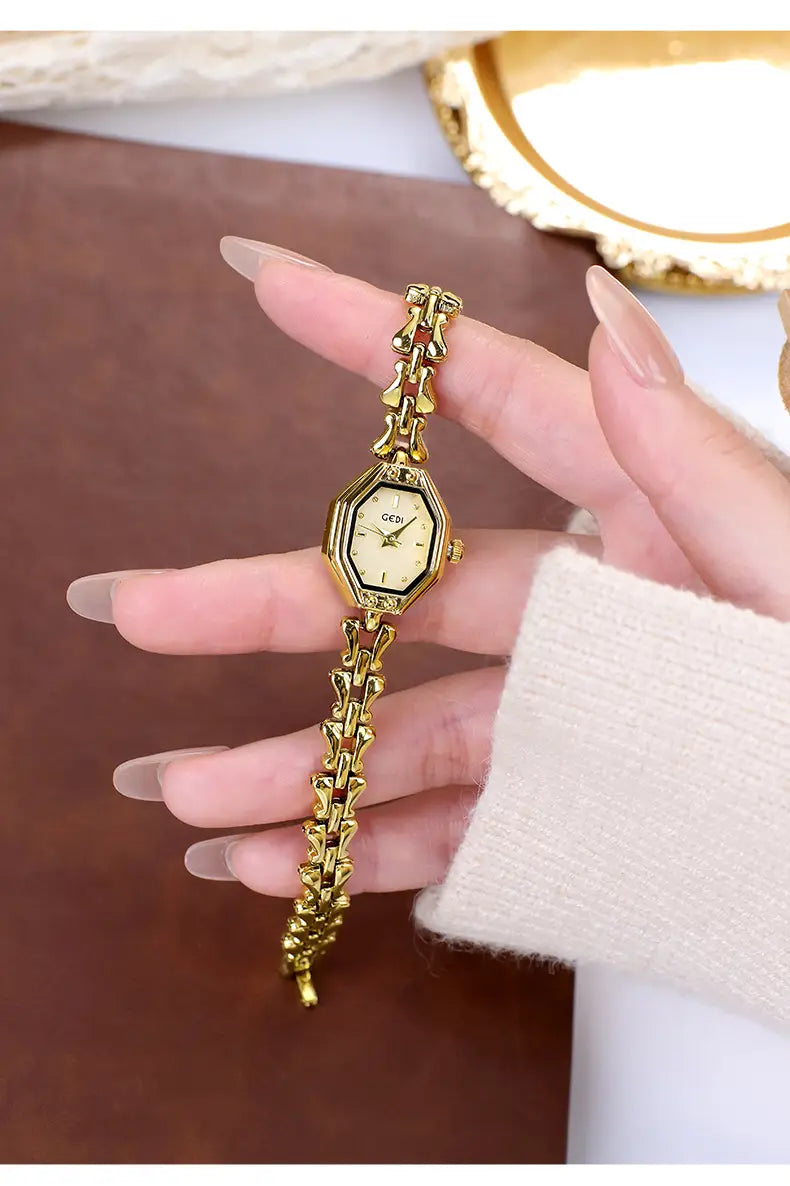 Gold-toned octagonal quartz watch with a delicate chain bracelet and cream-colored dial designed for ladies luxury wear.