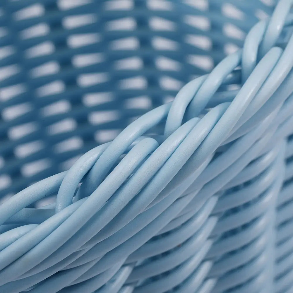 Light blue woven plastic kids bicycle basket with a uniform interlaced pattern designed for a basket set with bell and tassels.