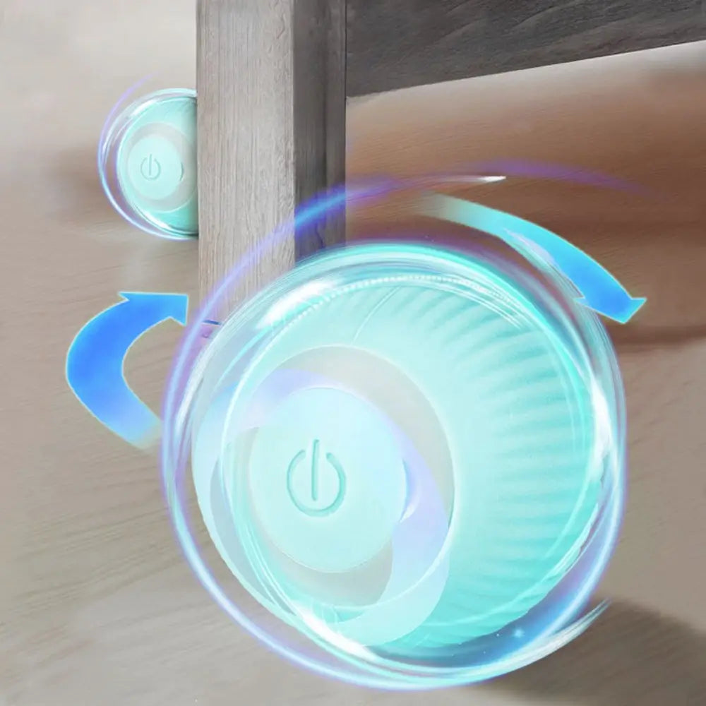 An automatic interactive smart cat ball toy in translucent teal with a power button and glowing blue motion lines indicating activity.