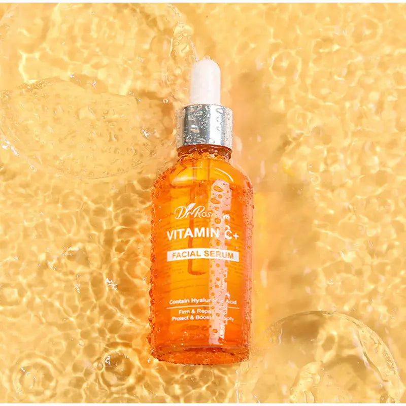 orange glass bottle of dr vitamin c brightening skincare set showing the front label with product details