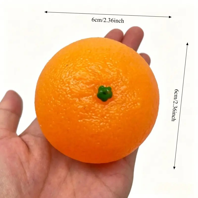 Jouet sensoriel d’anti-stress en silicone orange vibrant, conçu avec une tige verte afin d’évoquer un véritable fruit d’agrumes.