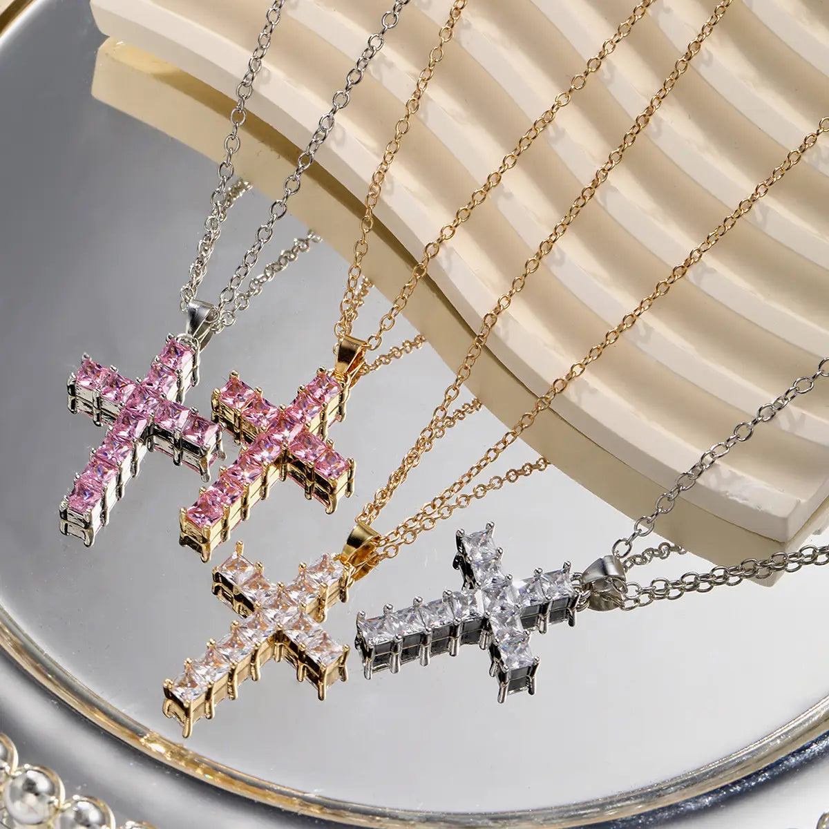 Four cross-shaped female pendants gold necklaces with faceted pink, clear, and rose gold-toned crystals displayed on matching chains for fashion necklaces female.