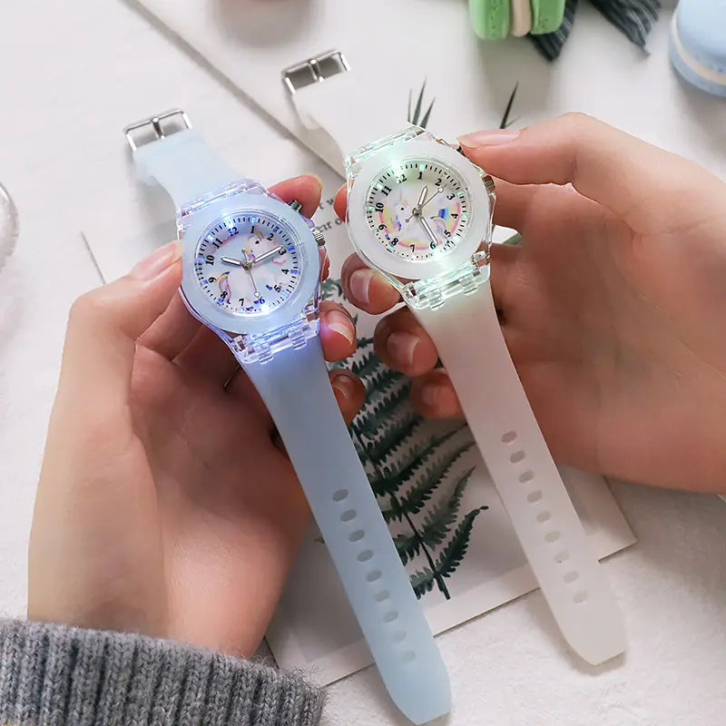 two translucent light-blue silicone wristband kids unicorn led light up digital watches with glowing faces and cartoon character designs