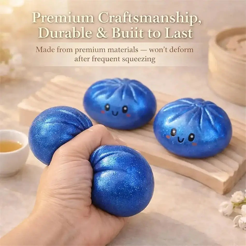 Blue glittery stress ball dumpling squishy with a smiling face in box for stress relief and fidgeting gift