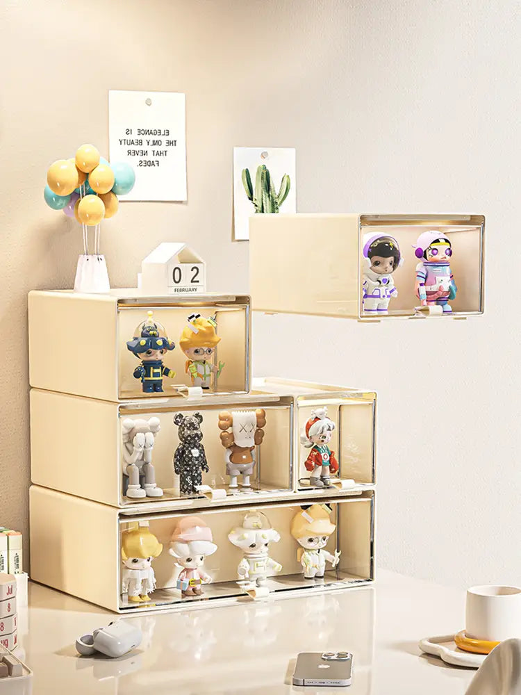 Beige transparent acrylic desktop organizer and collectible display case with mirrored sides housing colorful uniquely designed collectible figurines.