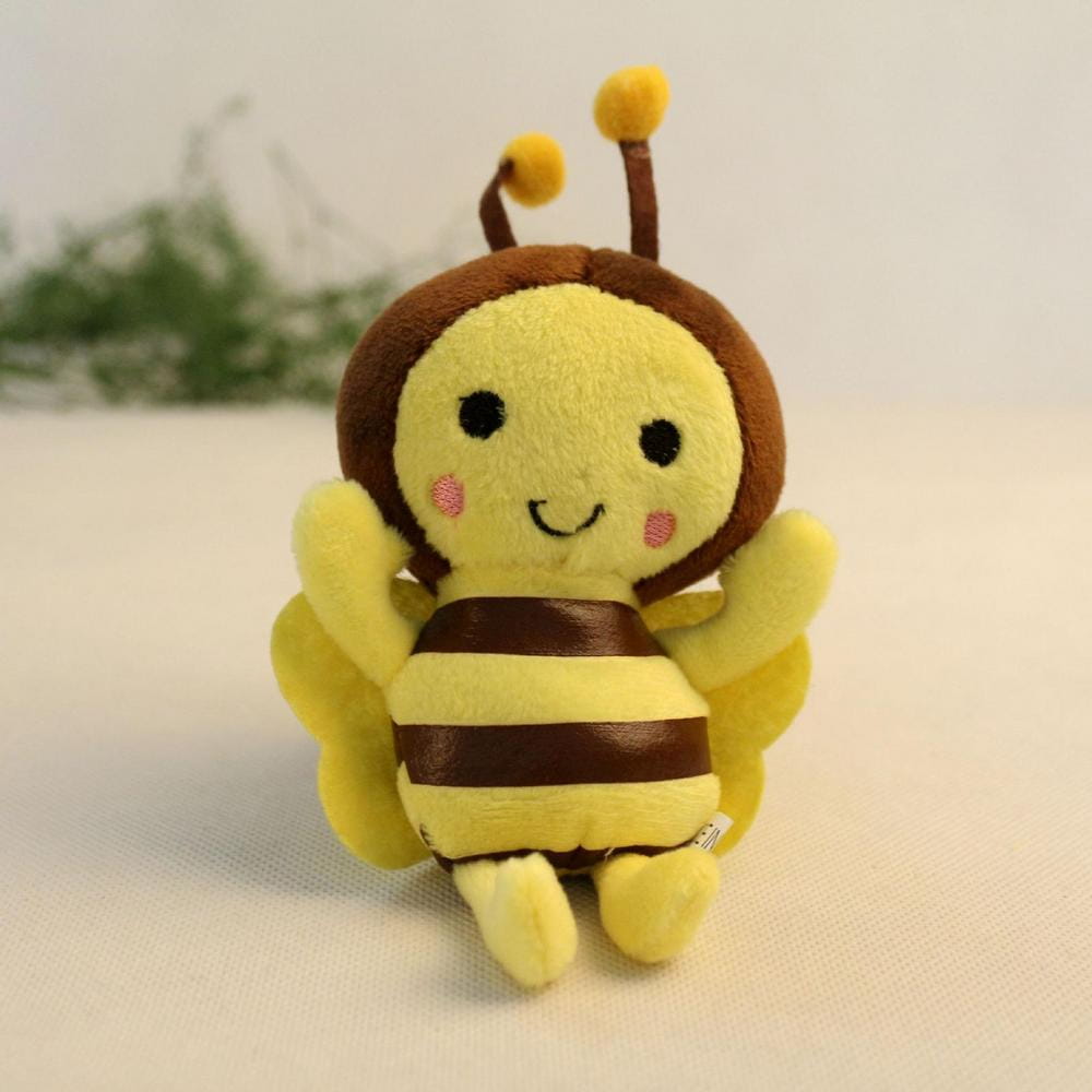 a soft yellow and brown bee stuffed animal plush toy with embroidered black eyes pink cheeks and striped abdomen