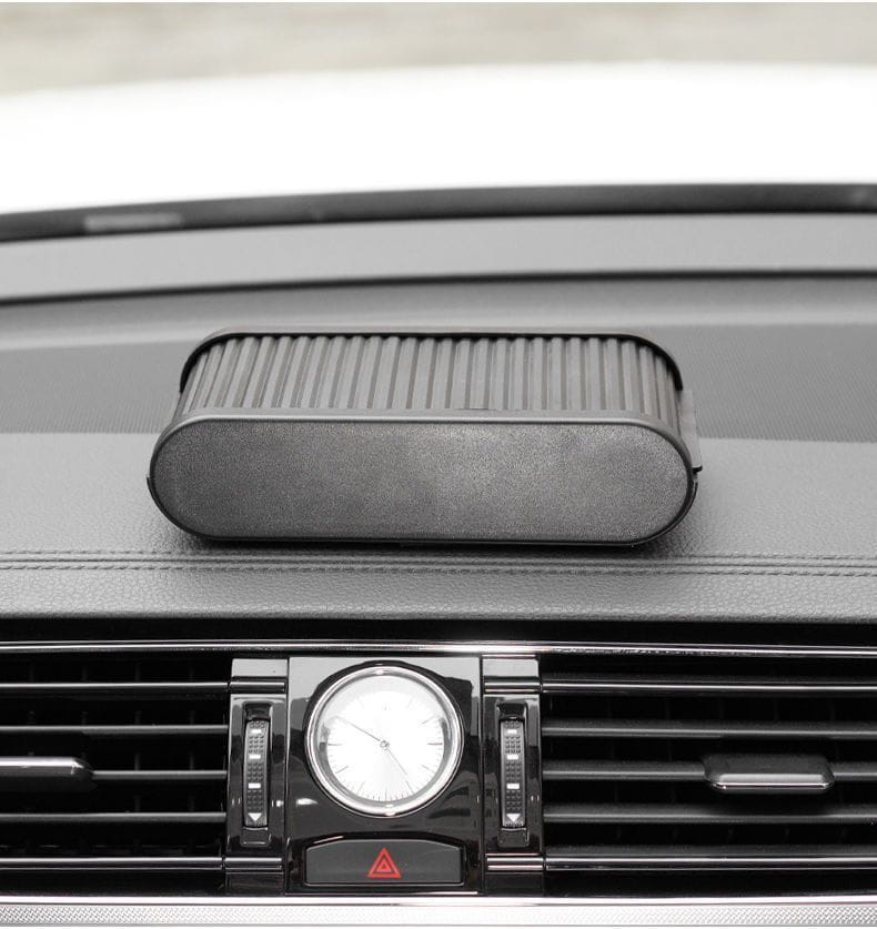 Black textured rectangular car dashboard organizer with lid and ribbed sides featuring a coin holder for vehicle use.