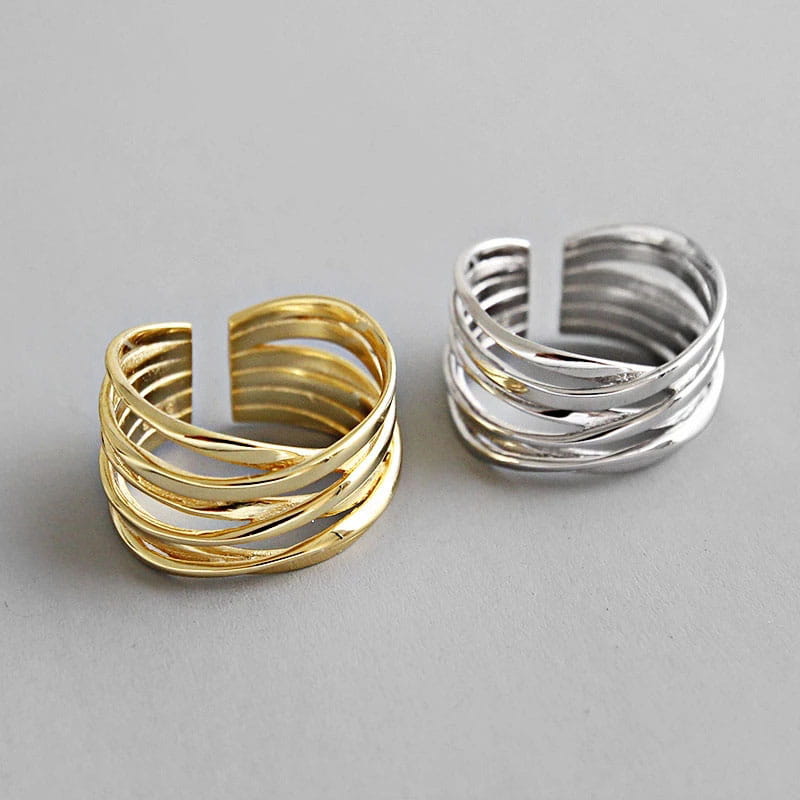 Sterling silver open rings for women featuring gold and silver layered twisted band designs.