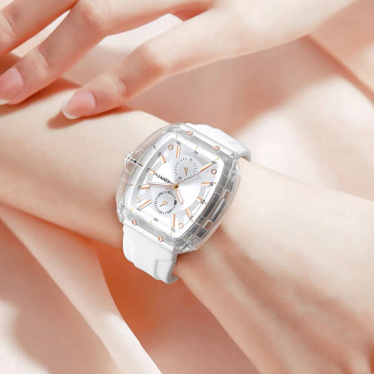 A transparent square-faced silicone casual watch with a white silicone strap and rose gold accents on a rectangular dial.