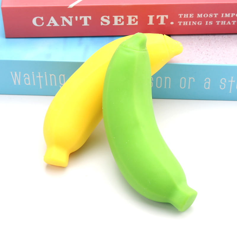 Two smooth glossy silicone banana toys slow rising stress relief toys in yellow and green with a side view.