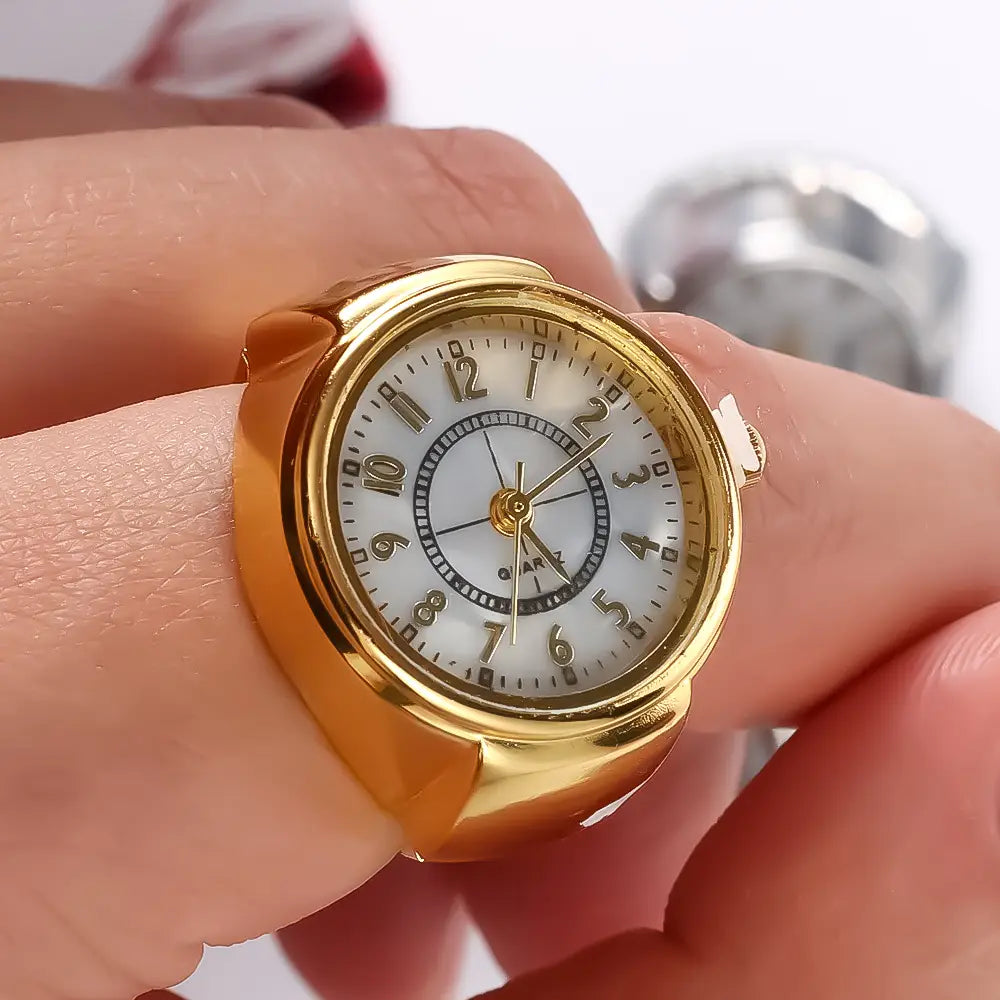 Gold-toned ring watch with a white dial, black numerals and hands, featuring quartz movement, designed as unisex finger jewelry and a perfect gift.
