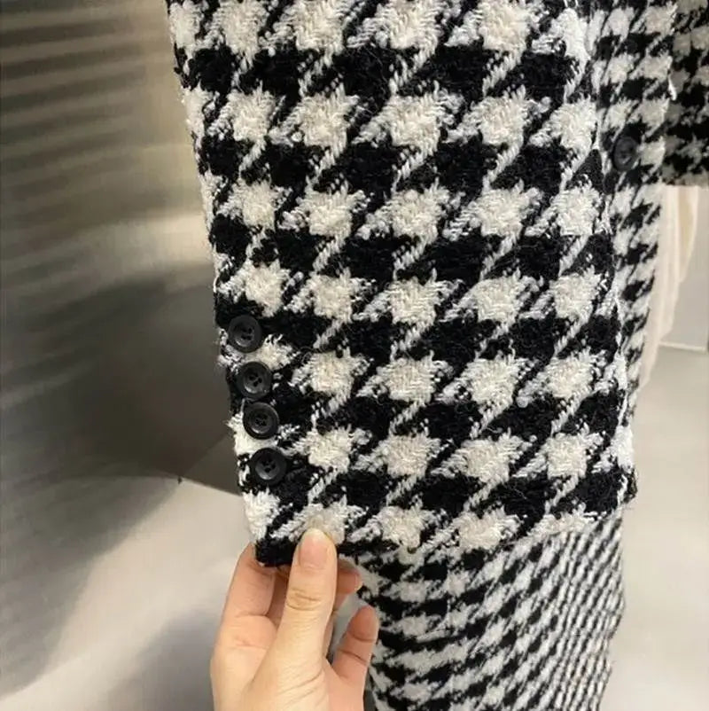 Black and white houndstooth wool double breasted coat with black buttons.