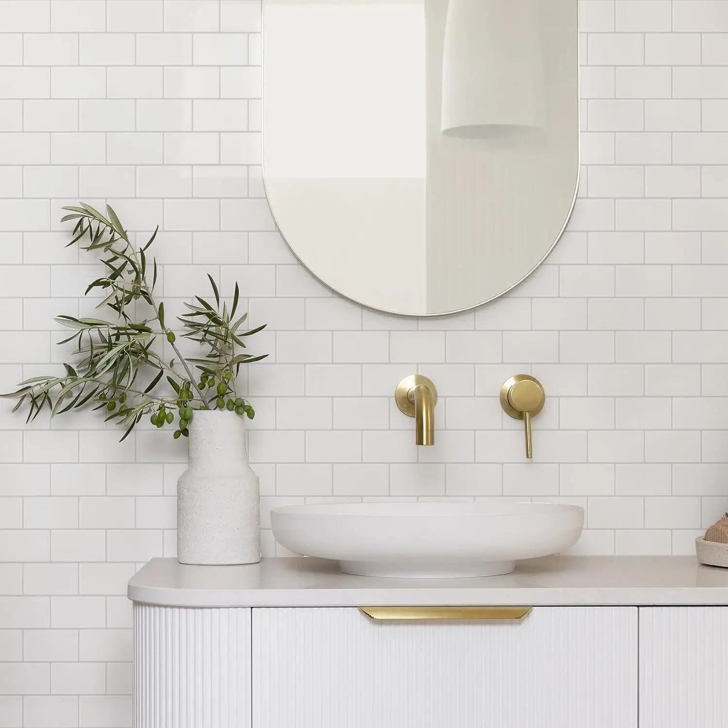 white ceramic vessel sink with sleek modern design and smooth rounded edges displayed with glossy white subway peel and stick tile suitable for direct contact application over fresh paint.