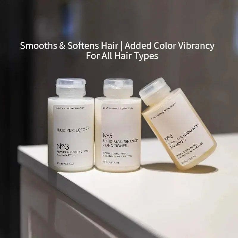 three sleek off-white bottles of bond maintenance hair care series shampoo and conditioner with minimalist labels and clear caps designed for frizz repair split ends control