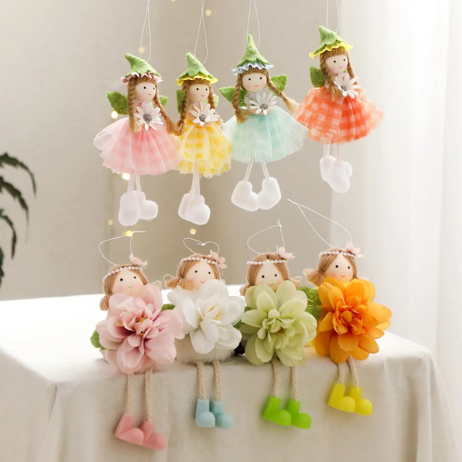 Easter fairy hanging ornaments 4-pack featuring cute pastel-colored fairies with embroidered faces, lace-like dresses in pink, yellow, and mint green, and matching felt or fabric hats.
