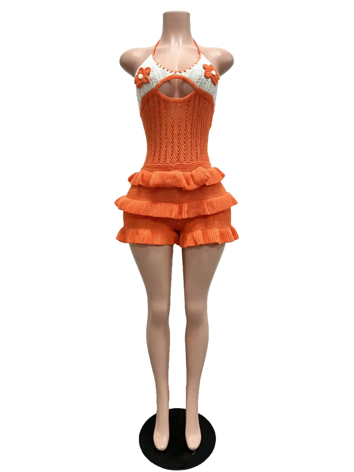 Orange crocheted knitted ruffle halter romper summer playsuit with white floral embellishments and ruffled shorts.