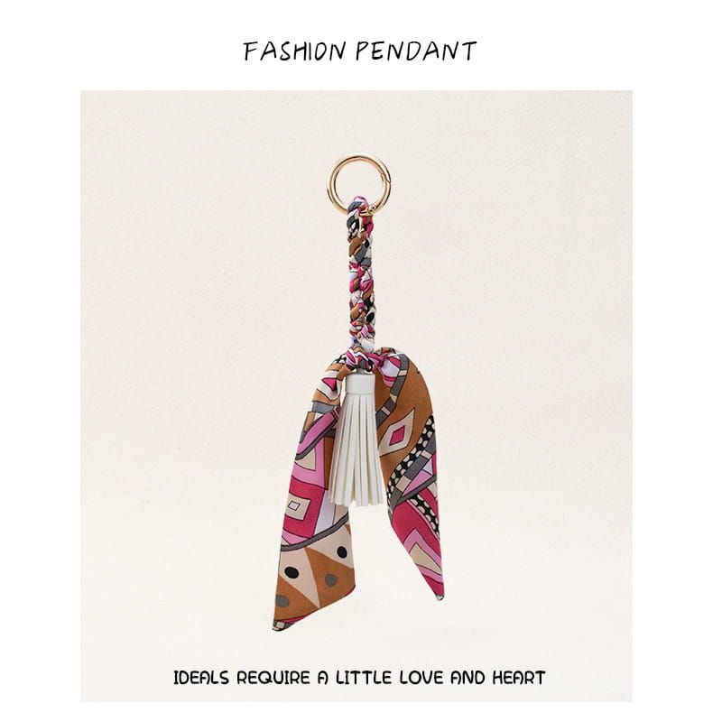 Porte-clés à gland de foulard en soie pour sacs, avec un foulard en soie à motif coloré, un cordon tressé et un gland blanc.