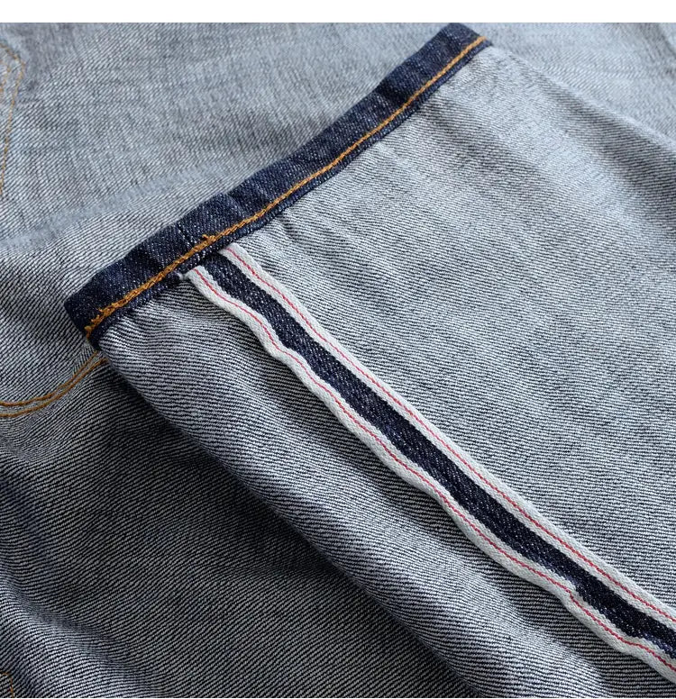 Heavyweight red selvedge denim jeans in light-wash denim featuring a dark blue selvedge edge with contrasting orange stitching and double-stitched seam details.