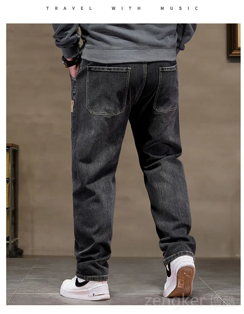 Plus size elastic waist loose straight dark-wash denim jeans shown from the back with relaxed fit and classic back pockets.