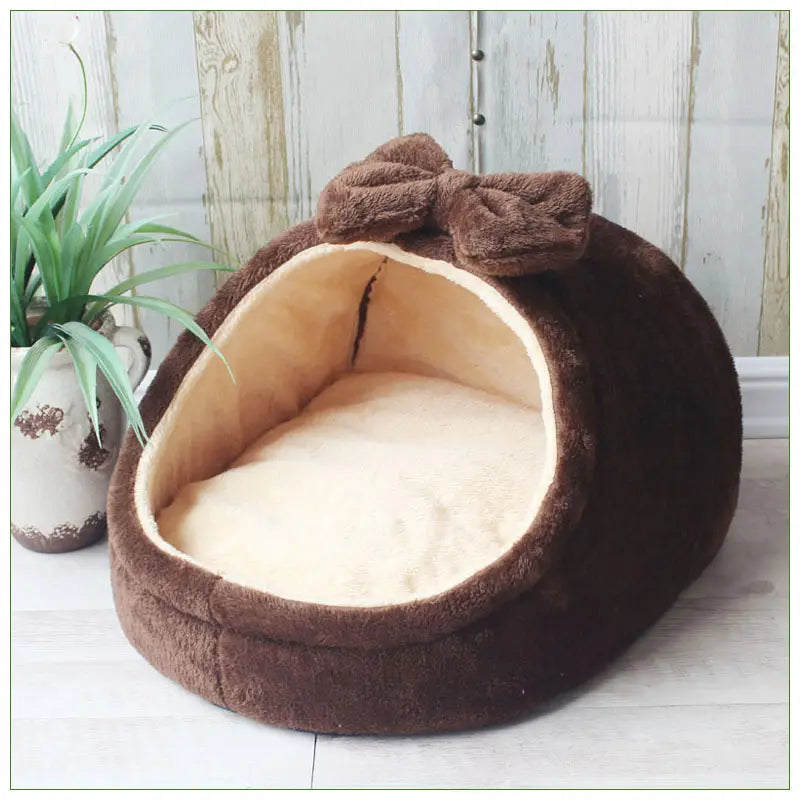 Brown foldable plush pet cave bed for small dogs and cats featuring a matching bow on top and a soft beige interior.
