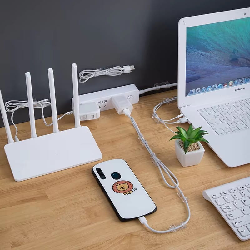 white phone case with a cartoon lion design shown from the back side used as a cable organizer clips desktop cord management holder