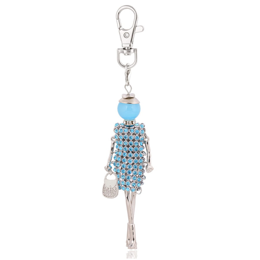 A delicate blue rhinestone detailed figurine keychain with a silver toned metal body and head featuring an attached small metallic purse charm for women bag pendant.