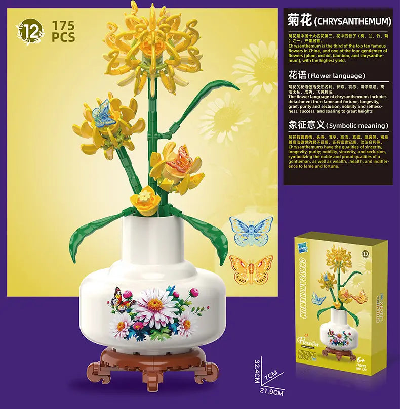 A white ceramic vase with colorful floral and butterfly decals holding a yellow chrysanthemum bouquet made from 175 interlocking Lego compatible building blocks potted plant toy.
