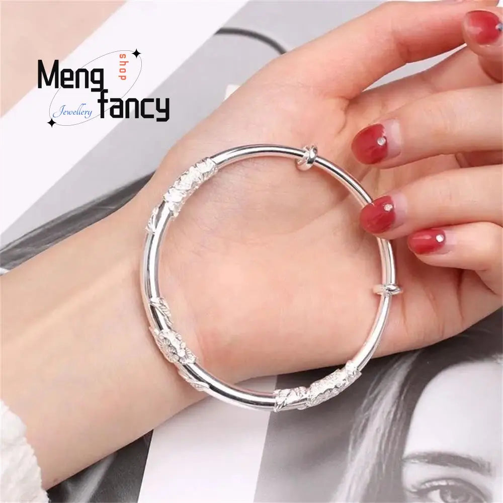 Silver bangle bracelet with intricate engraved patterns and small embedded stones featuring a sleek adjustable clasp designed for natural jade raw stone floral sliding bangle collection.