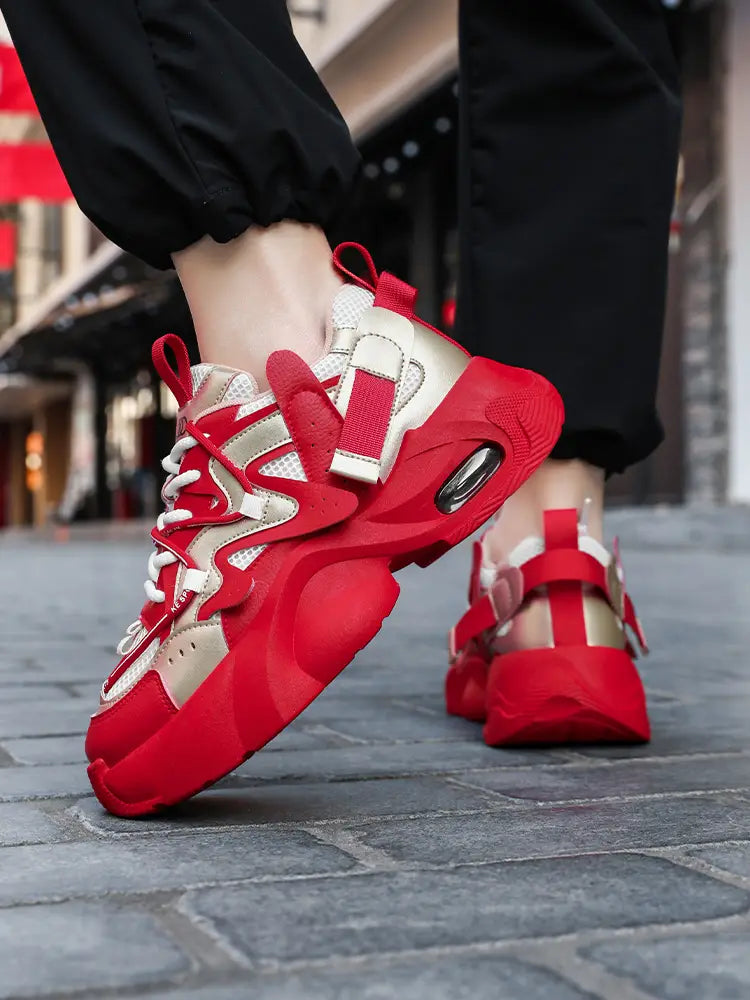 Men chunky air cushion casual sneakers in red and beige featuring bold red straps, white laces, and a visible air cushion unit in the heel.