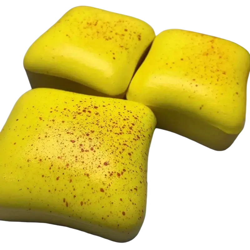 Three bright yellow square silicone slow rising squishy stress balls with speckled orange texture for stress relief