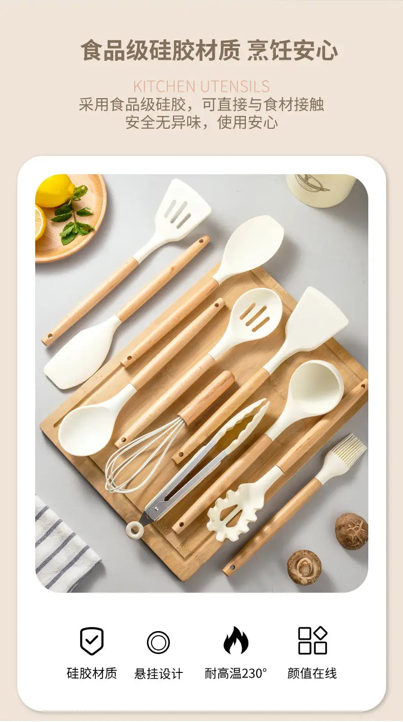 Set of white silicone kitchen utensils with wooden handles including spatulas spoons a whisk tongs and a brush for cooking and baking.