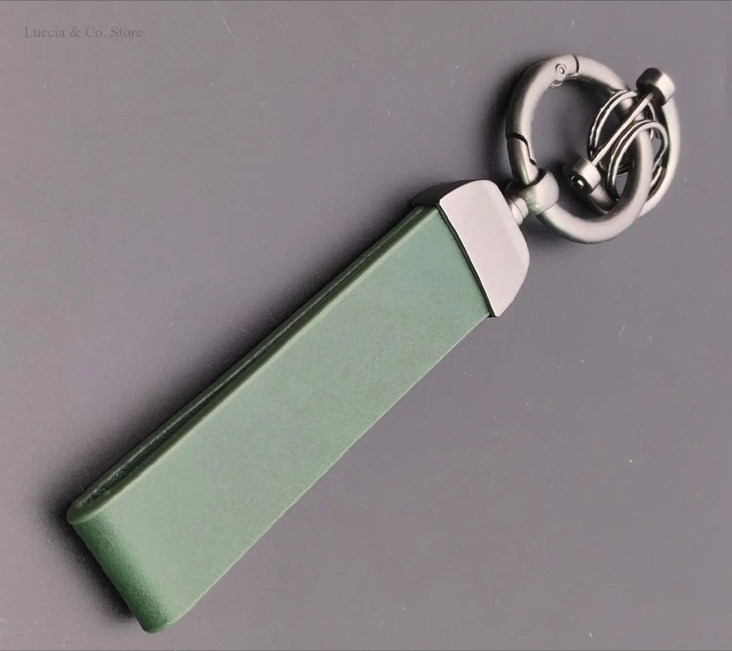 custom logo car keychain personalized metal leather ring in sleek sage green leather with polished silver-toned metal clasp and ring for secure key organization