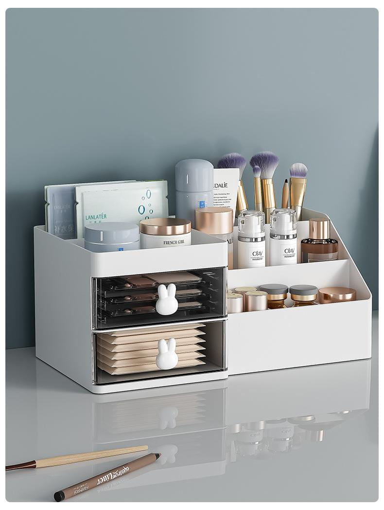 White two-drawer makeup storage box with large capacity and transparent sliding compartments featuring bunny-shaped handles in modern minimalist style cream organizer.