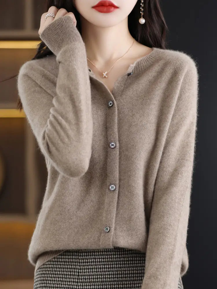 Beige merino wool cardigan for women featuring a soft cashmere knit with a textured fabric and subtle button closure.
