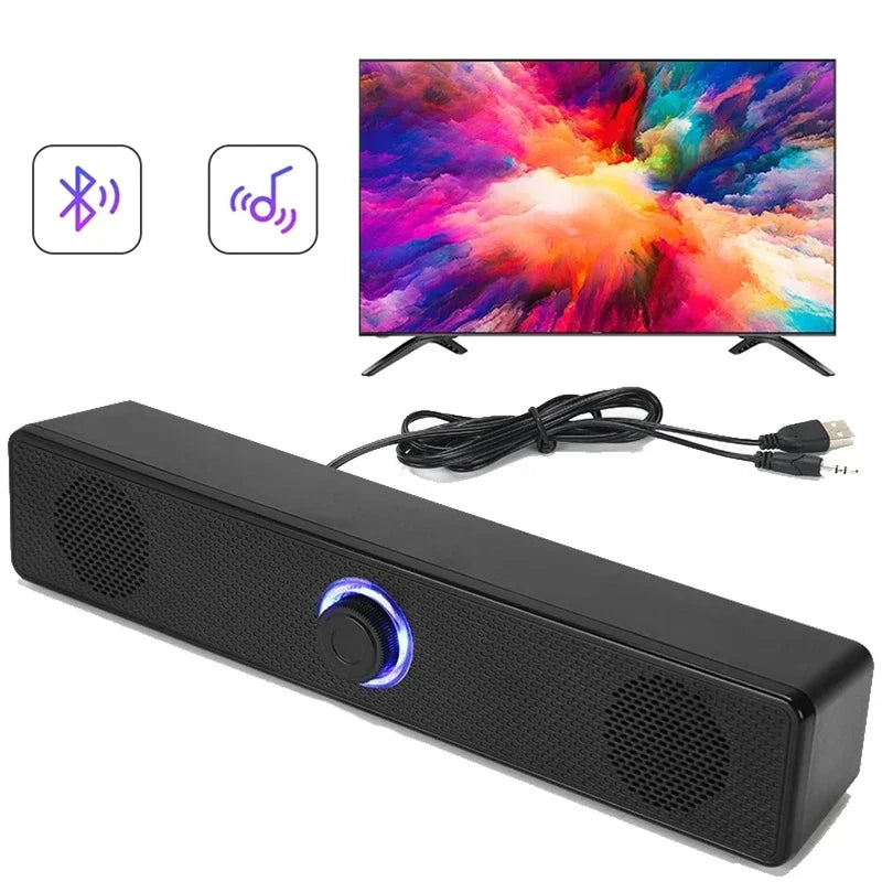 Black rectangular pc soundbar with textured surface blue illuminated control knob and dual speaker grilles for desktop use