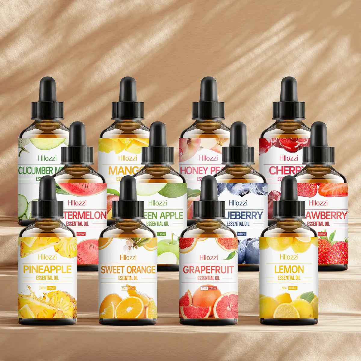 a collection of hillozzi essential oil bottles with black dropper caps and clear glass bodies featuring fruit-scented oils for skin care including cucumber melon mango honey peach cherry pineapple sweet orange and grapefruit in an essential oil fruit set