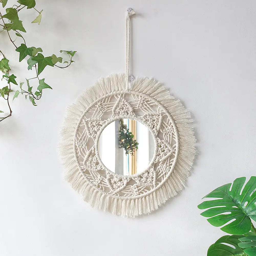 Cream-colored boho macrame wall mirror with intricate woven patterns and fringe detailing for living room home decor.